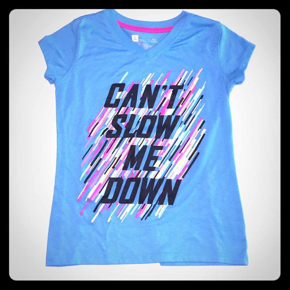 A blue top with letters saying“can’t slow me down”